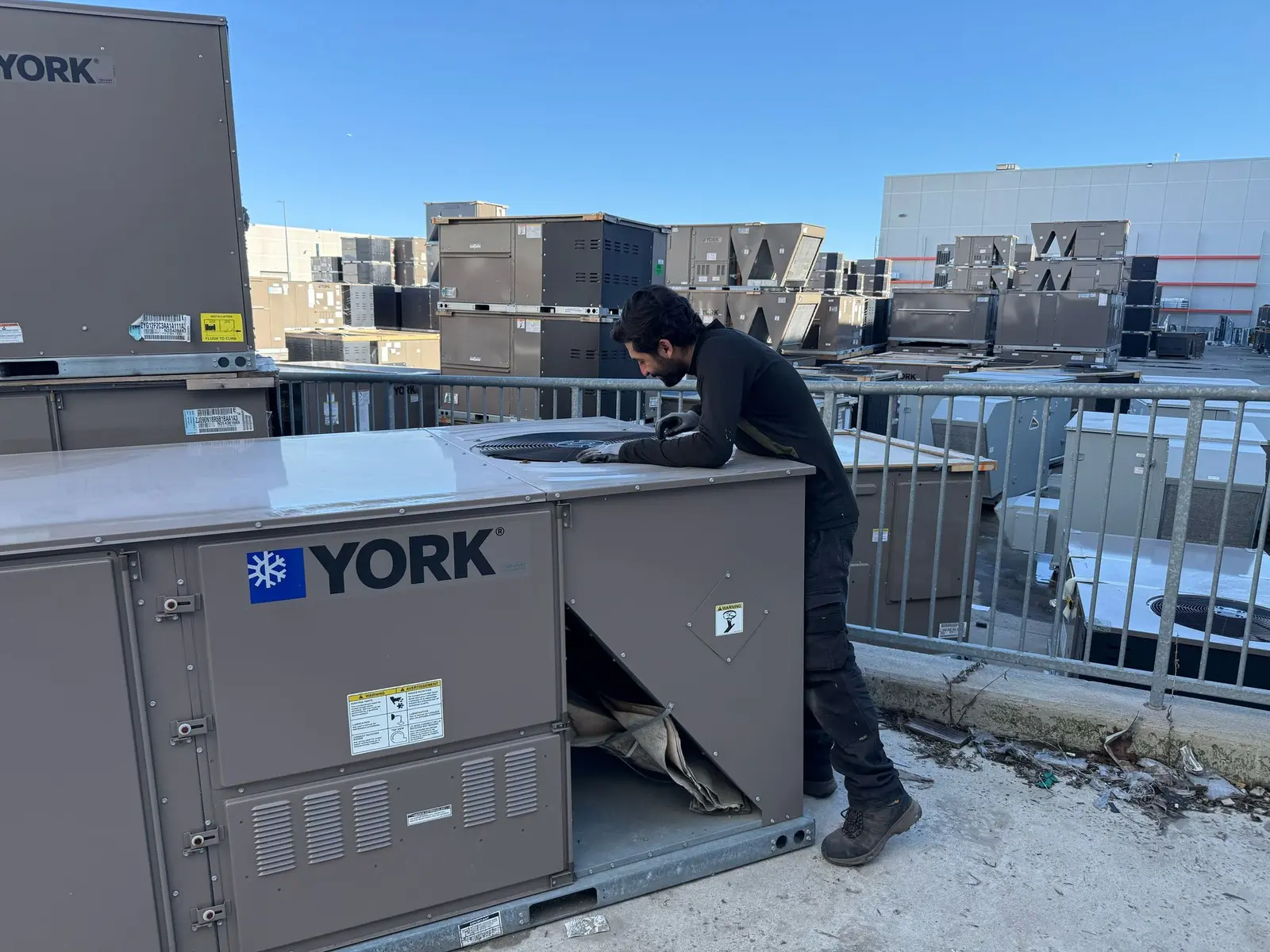 Tech Cooling technician servicing a York commercial rooftop unit