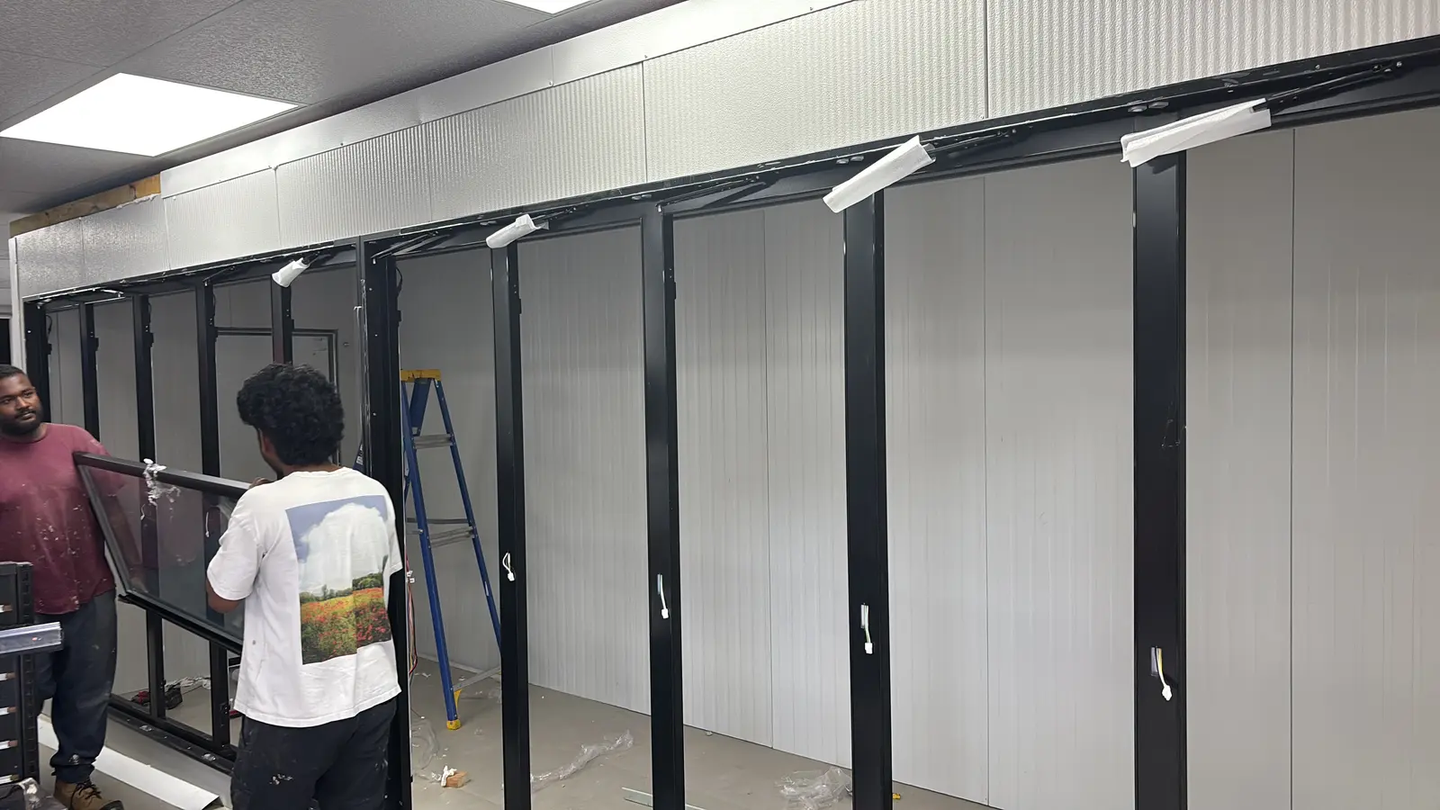 Tech Cooling crew installing glass doors on a walk-in cooler